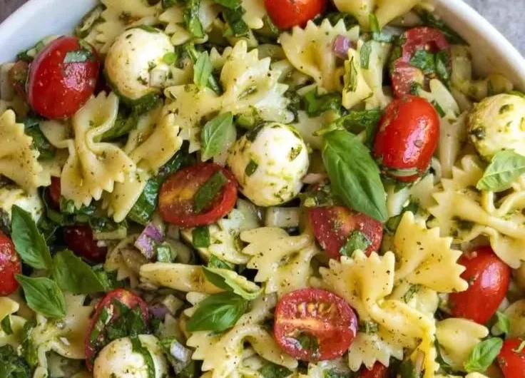 Colorful Bow Tie Pasta Salad with fresh vegetables and dressing