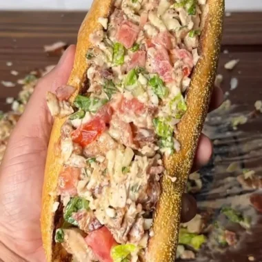 Chopped chicken bacon ranch sub sandwich with toppings on a platter