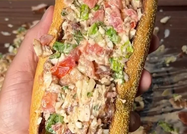 Chopped chicken bacon ranch sub sandwich with toppings on a platter