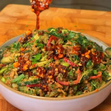 Delicious crispy rice salad with fresh vegetables and a tangy dressing.