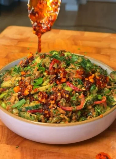 Delicious crispy rice salad with fresh vegetables and a tangy dressing.