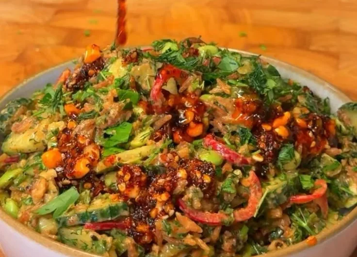 Delicious crispy rice salad with fresh vegetables and a tangy dressing.
