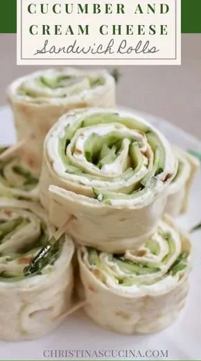 Cucumber and cream cheese sandwich rolls served on a plate