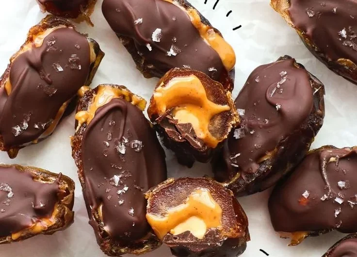 Homemade Date Snickers bars made with dates, nuts, and chocolate
