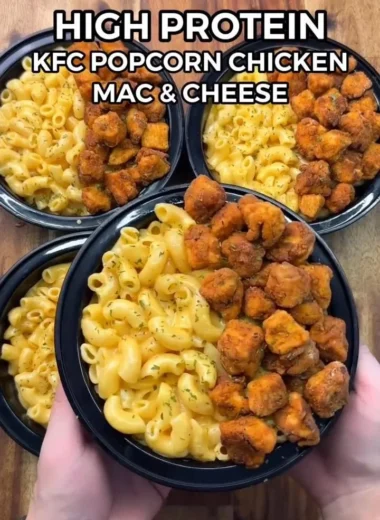 Bowl of KFC Chicken Mac & Cheese topped with crispy chicken strips.