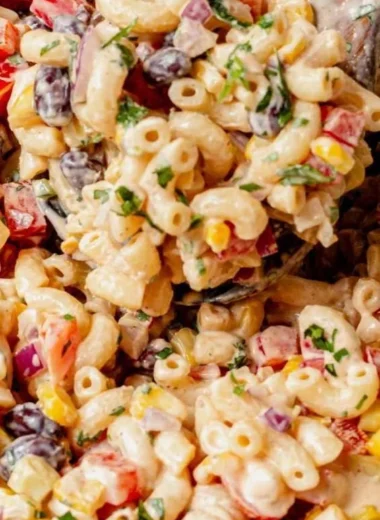 Bowl of colorful Mexican Macaroni Salad with fresh vegetables and spices
