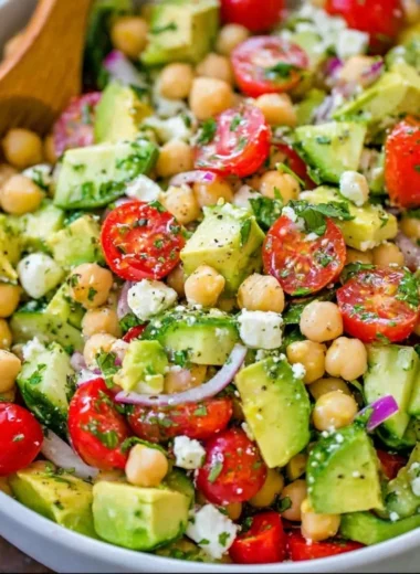 Delicious chickpea salad with fresh vegetables and herbs in a bowl.