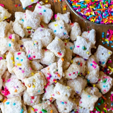 Delicious cake batter puppy chow snack mix with colorful sprinkles.