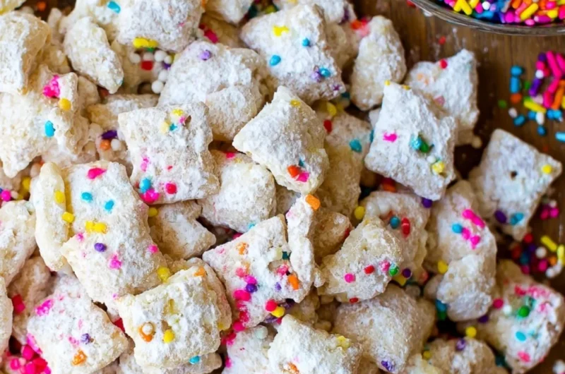 Delicious cake batter puppy chow snack mix with colorful sprinkles.