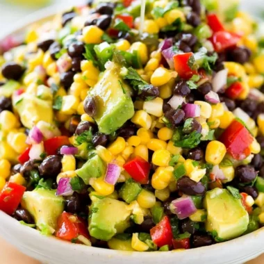Bowl of colorful Cowboy Caviar featuring beans, corn, and vegetables