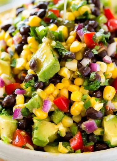 Bowl of colorful Cowboy Caviar featuring beans, corn, and vegetables