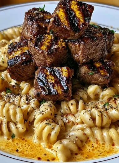 Creamy garlic butter steak bites with spicy Cajun Alfredo pasta dish