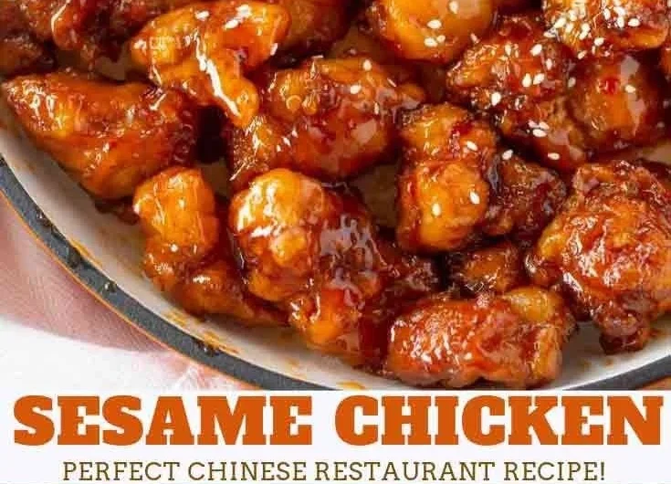Plate of crispy sesame chicken garnished with sesame seeds and green onions.