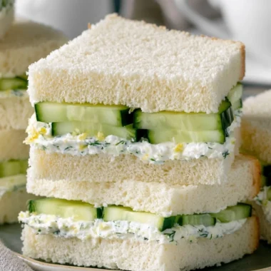 A plate of easy cucumber sandwiches on a floral tablecloth