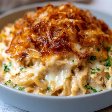 Delicious French Onion Chicken Orzo Casserole topped with melted cheese
