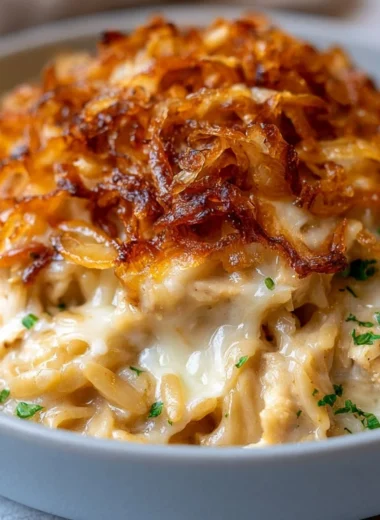 Delicious French Onion Chicken Orzo Casserole topped with melted cheese