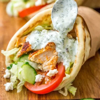 Delicious homemade chicken gyro served with fresh veggies and tzatziki sauce.