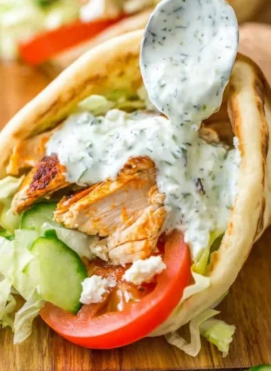Delicious homemade chicken gyro served with fresh veggies and tzatziki sauce.