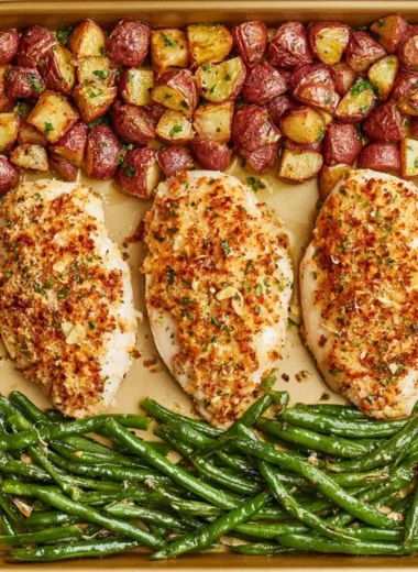 Parmesan Crusted Chicken on a sheet pan with vegetables, perfect for a quick dinner.