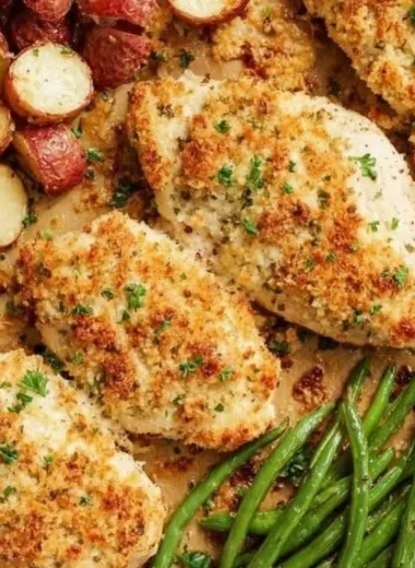 Delicious Parmesan Crusted Chicken on a sheet pan with vegetables