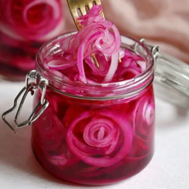Jar of quick pickled red onions for tasty meal enhancements