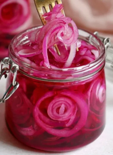 Jar of quick pickled red onions for tasty meal enhancements