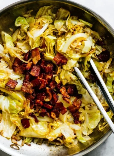 A pan of Southern Fried Cabbage cooked with seasonings and bacon.