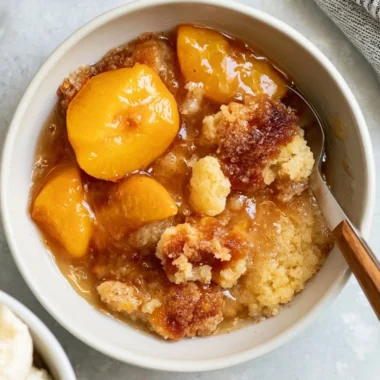 Delicious homemade Southern peach cobbler served in a rustic dish.