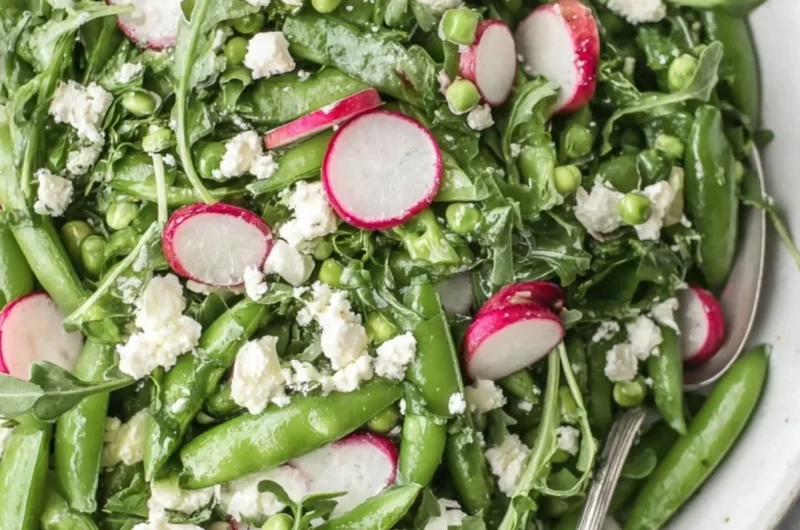 Delicious sugar snap pea salad with fresh vegetables and dressing
