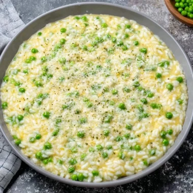 Delicious warm and creamy rice and peas served in a bowl