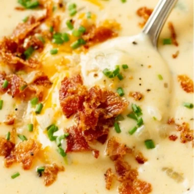 Delicious bowl of homemade baked potato soup topped with chives and cheese