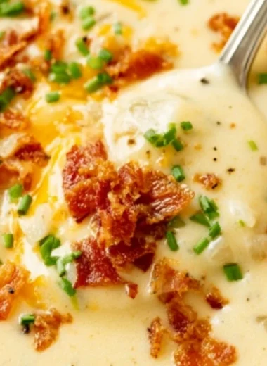 Delicious bowl of homemade baked potato soup topped with chives and cheese