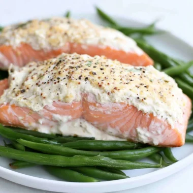 Baked salmon fillet with a sour cream crust on a plate