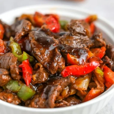 Plate of delicious black pepper beef served with vegetables and rice