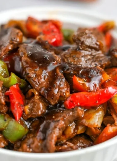 Plate of delicious black pepper beef served with vegetables and rice
