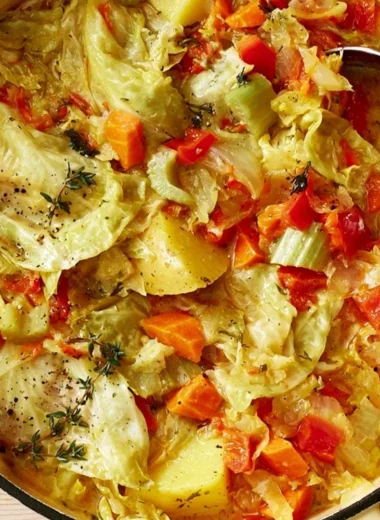 Bowl of healthy cabbage soup for weight loss on a wooden table