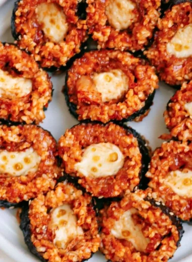 Delicious Cheese Kimchi Kimbap featuring vibrant kimchi and melted cheese roll.