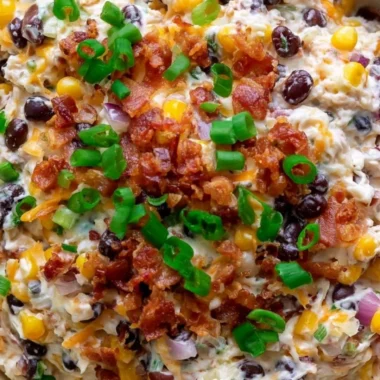 Delicious Cowboy Corn Dip served in a bowl with tortilla chips.