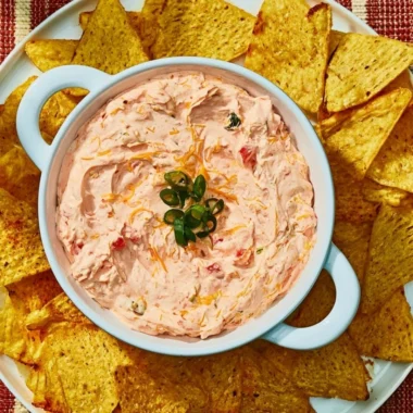 Delicious Cozy Boat Dip served in a bowl with fresh vegetables and crackers.