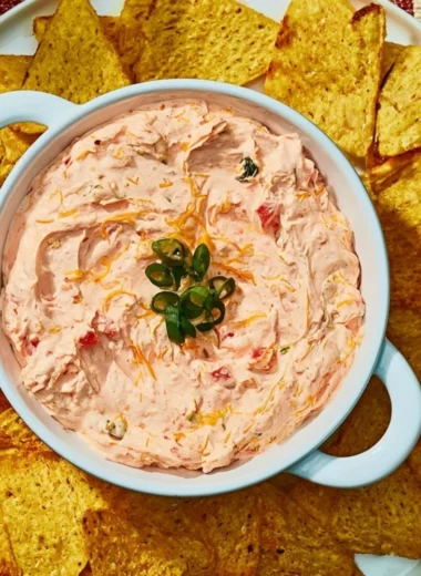 Delicious Cozy Boat Dip served in a bowl with fresh vegetables and crackers.