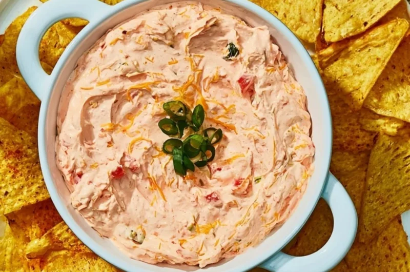 Delicious Cozy Boat Dip served in a bowl with fresh vegetables and crackers.