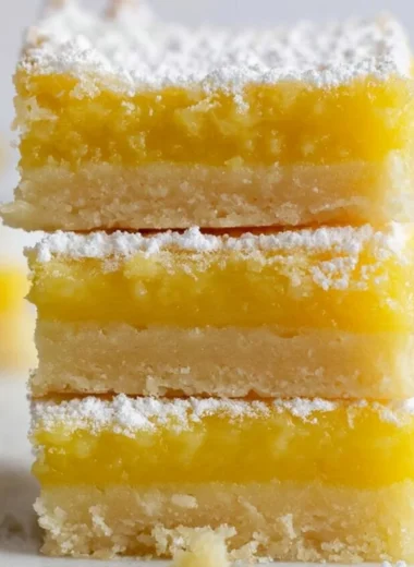 Delicious homemade cozy easy lemon bars on a plate with lemon slices