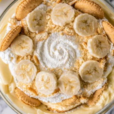Cozy homemade banana pudding topped with fresh bananas and whipped cream
