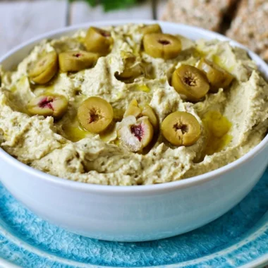 Cozy Olive Hummus dip served with fresh vegetables