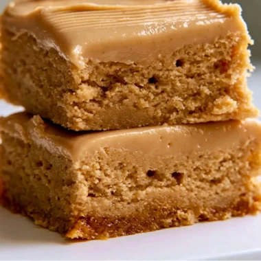 Cozy Peanut Butter Lunch Lady Bars topped with chocolate and peanut butter drizzle