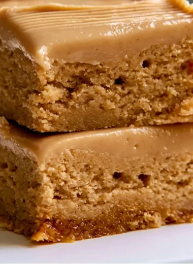 Cozy Peanut Butter Lunch Lady Bars topped with chocolate and peanut butter drizzle