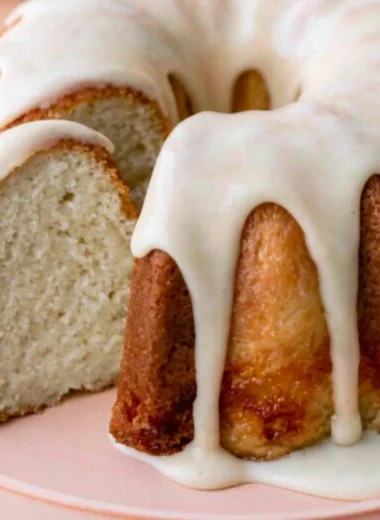 A moist and delicious vanilla bundt cake displayed on a decorative plate.