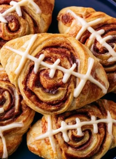 Football-shaped cinnamon rolls fresh out of the oven, perfect for game day.