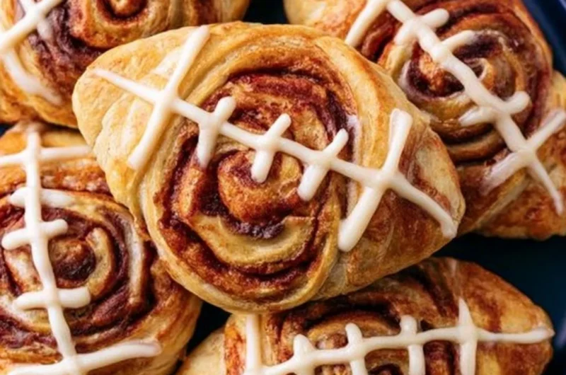 Football-shaped cinnamon rolls fresh out of the oven, perfect for game day.