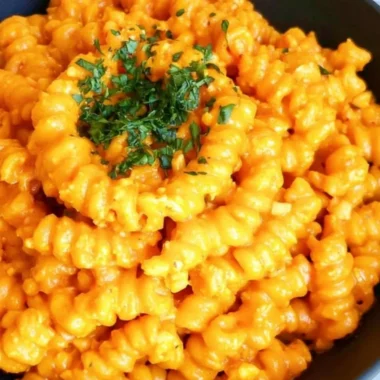 Bowl of Gochujang Pasta topped with fresh herbs and chili flakes